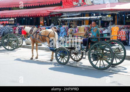 Yogyakarta, Indonesien - November 20 2021 : das dokar, delman oder andong ist ein traditionelles Transportmittel, das einen von einem Pferd gezogenen Wagen verwendet Stockfoto