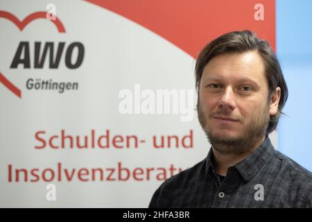 PRODUKTION - 17. Dezember 2021, Niedersachsen, Göttingen: Thomas Bode, Leiter der Schuldenberatung der AWO Göttingen, steht vor einem Display. (To dpa: ''Es kann jedem passieren' - Schuldenberatung hilft in der Corona Times') Foto: Swen Pförtner/dpa Stockfoto