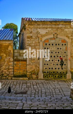 Eine Katze und ein Gespenst, gezeichnet auf die Wand eines alten zerstörten Hauses in Buonalbergo, einem Dorf, das nach einem Erdbeben in der Provinz Benevento, Italien, wieder aufgebaut wurde. Stockfoto