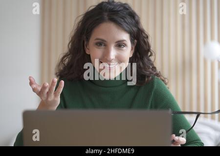 Lächelnde junge italienische Frau Lehrer Tutor spricht mit Schülern während Online-Unterricht auf Laptop Stockfoto