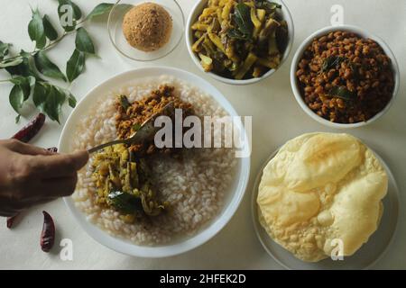 Reisbrei oder Kanji zusammen mit würzigem, kälteem Kokosnussrot-Chutney, gebratenen gekochten roten Kuhpeibohnen und gebratenen rohen Bananenscheiben. Ein Favorit m Stockfoto