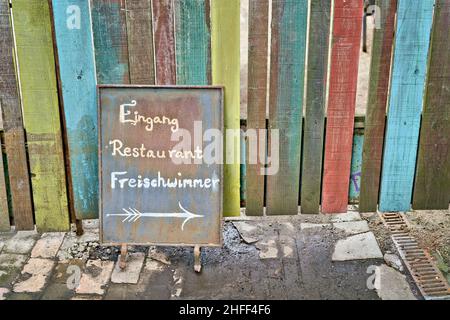 Schild am Eingang des beliebten Restaurants Freischwimmer am Flutgraben in Berlin. Übersetzung auf dem Schild: Eingang Restaurant Freischwimmer Stockfoto