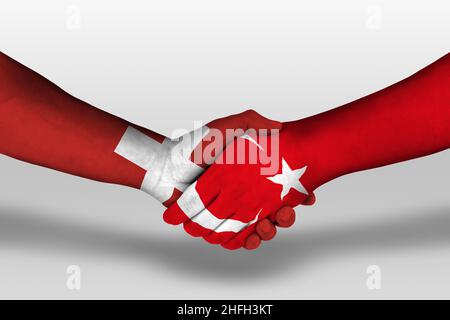 Handschlag zwischen türkei und schweiz Flaggen auf Händen gemalt, Illustration mit Clipping path. Stockfoto