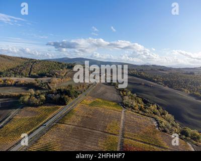 Luftpanorama auf den Hügeln des Val d'Orcia in der Nähe von Pienza, Toskana, Italien. Toskanische Landschaft mit Zypressen, Weinbergen, Wäldern und gepflügten Feldern Stockfoto