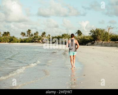 Junger Mann, der an der Küste des Atlantischen Ozeans entlang läuft Stockfoto
