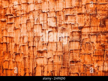 Orangefarbene Farbtextur an der Wand Stockfoto