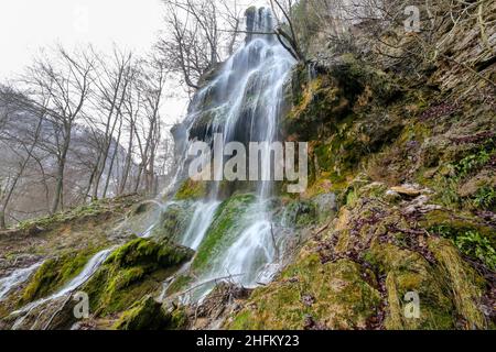 Bad Urach, Deutschland. 16th Januar 2022. Beim Wasserfall in Bad Urach fällt Wasser in die Tiefe. Der Urach-Wasserfall gehört zu den Sehenswürdigkeiten des UNESCO-Weltgeoparks Schwäbische Alb und des von der UNESCO anerkannten Biosphärenreservats Schwäbische Alb. Quelle: Thomas Warnack/dpa/Alamy Live News Stockfoto