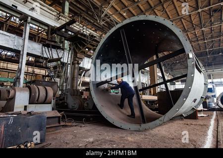 USt'-Kamenogorsk, Kasachstan-Mai 31,2012: Fabrik in Wostokmashzawod. Schwertechnikanlage. Arbeiter in einem riesigen Metallring. Qualitätskontrolle. Stockfoto