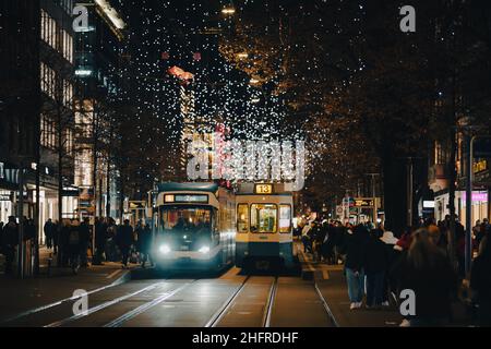 Zürich, Schweiz - 12 2021. Dezember: Eine Straßenbahn fährt entlang der Bahnhofstrasse, der Hauptstraße in der Zürcher Innenstadt mit weihnachtlicher Dekoration Stockfoto