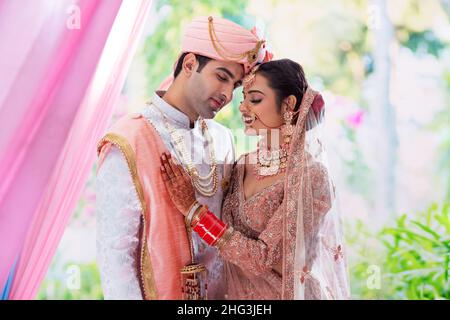 Porträt eines indischen Brautpaares, das für ein Fotoalbum posiert Stockfoto