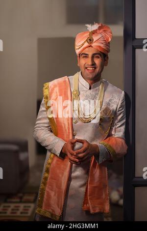 Portrait eines gutaussehenden Bräutigams, der in einem reichen indianischen Stil für die Hochzeit gekleidet ist Stockfoto