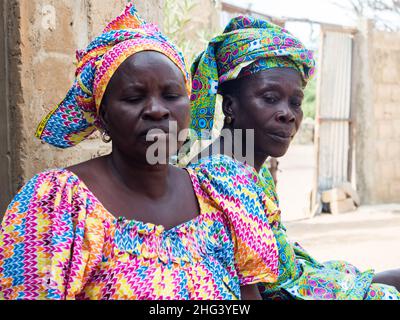 Senegal, Afrika - Jan, 2019: Senegalesische Frauen in einer traditionellen Tracht namens 'boubou' und einer Schaukel auf ihrem Kopf Stockfoto