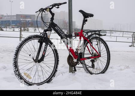 Radfahren im Winter. Im Winter ist ein Fahrrad im Schnee verkettet Stockfoto