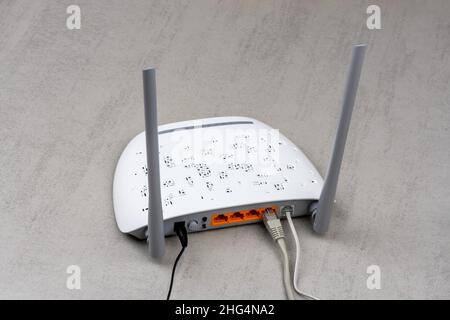 Neuer weißer Wi-Fi-Router mit grauen Antennen auf der Rückseite mit grauem Hintergrund Stockfoto