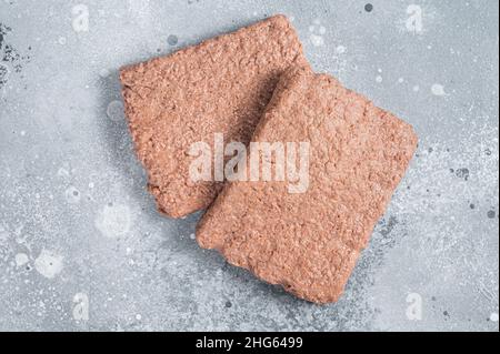 Rohes Fleisch auf pflanzlicher Basis, Lebensmittel reduzieren den CO2-Fußabdruck. Grauer Hintergrund. Draufsicht Stockfoto