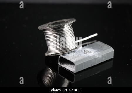Lötdraht mit kleinem Kunststoffsockel, der das Konzept einiger elektronischer Projektarbeiten zeigt Stockfoto