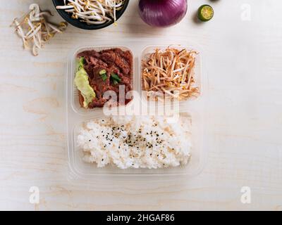Traditioneller arabischer Reis mit Lammaufschnitt, serviert in einer Schüssel auf grauem Hintergrund, Draufsicht Stockfoto