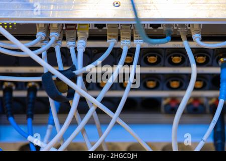 Internet-utp- oder Netzwerkkabel, die an einem Router oder Switch an einer tv-Produktionsengine oder -Box angeschlossen sind. Rückansicht eines Schaltfelds für Live-tv-Produktionen. Stockfoto