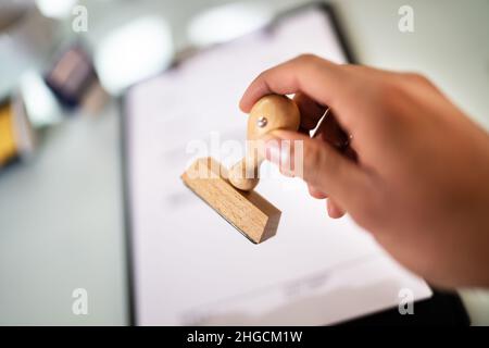 Öffentlicher Notar, Der Den Firmenstempel Auf Den Vertrag Am Büroschreibtisch Setzt Stockfoto