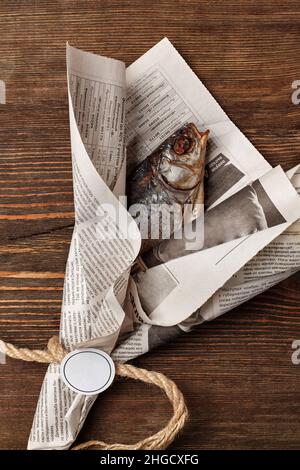 Gesalzene getrocknete Kakerlake, in einem newspapierähnlichen Bouquet verpackt Stockfoto