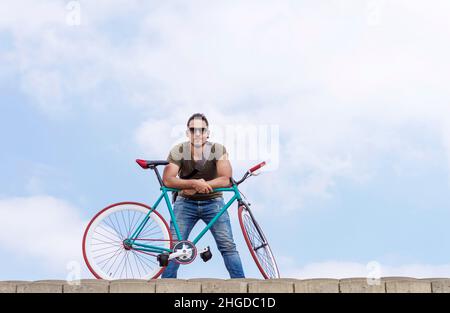 Junge Hipster Mann Reiten feste Ausrüstung Fahrrad auf Stadt Straße Stockfoto