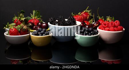Cherries and Berries on a dark background Stockfoto