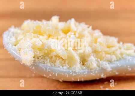 Kleine Stücke zerfetzter Kokosnuss mit weißem Zucker. Stockfoto