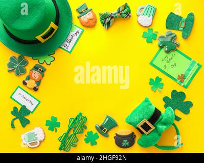 Rahmen aus leckeren Lebkuchengebäck für St. Patrick's Day Feier auf gelbem Hintergrund Stockfoto