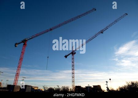 Baukräne ragen über einer Wohnanlage in der Innenstadt von Colorado Springs, Colorado Stockfoto