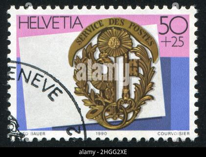 SCHWEIZ - UM 1990: Briefmarke gedruckt von der Schweiz, zeigt Emblem, Papier, um 1990 Stockfoto