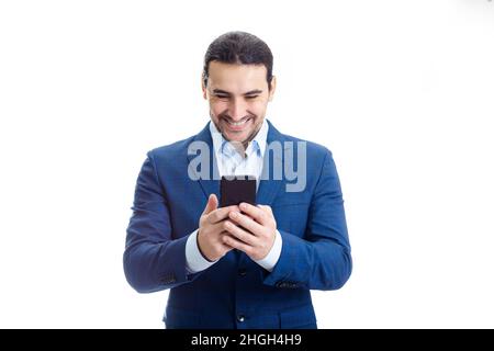 Porträt eines lächelnden Geschäftsmannes, der auf sein Telefon schaut und gute Nachrichten liest. Geschäftsmann erhält Nachrichten mit zufrieden positivem Projektergebnis auf seinem p Stockfoto
