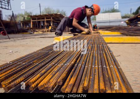 Montage von Bewehrungsstäben zum Ausgießen von Beton. Industrieller Hintergrund. Bewehrungsstruktur Bewehrungsstahl für Stahlbeton auf der Baustelle. Stockfoto