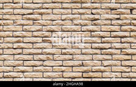 Nahtlose Hintergrundstruktur der dekorativen gelben Ziegelwand, Vorderansicht Stockfoto