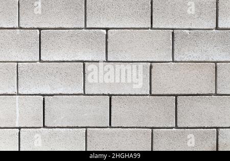 Eine Wand aus grauen Schaumbeton-Blöcken, Hintergrund-Foto-Textur Stockfoto