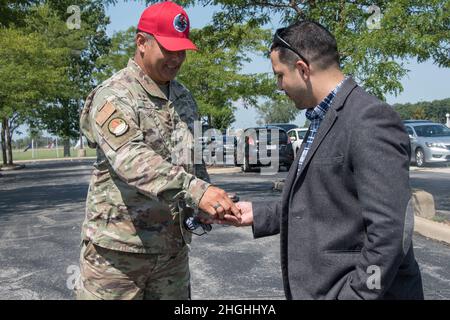 Col. Michael A. Hrynciw, Kommandant des roten PFERDES mit zwei Zähnen, übergibt nach seinem Besuch beim 200. ROTPFERD-Geschwader in Camp Perry, Port Clinton, Ohio, am 4. August 2021 eine Münze an Antonio Baez, Congressional Fellow. RED HORSE Leadership und zwei Gäste des Kongresses diskutierten den Plan VON RED HORSE, mehrere Gebäude durch eine effizientere Mehrzweckanlage zu ersetzen. Stockfoto