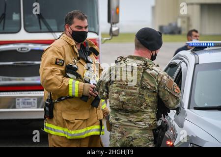 Brian Ellis (links), Leiter der Feuerwehr der Connecticut Air National Guard, und Mitarbeiter der US Air Force Sgt. Gerard St. George, 103. Sicherheitskräfte-Geschwader, reagiert auf ein kleines unbemanntes Flugzeugsystem, das während einer Drohnenreaktionsübung bei der Installation in East Granby, Connecticut, am 5. August 2021 über der Bradley Air National Guard Base fliegt. Angesichts der zunehmenden Verbreitung von Drohnenaktivitäten auf der ganzen Welt hat sich das 103. Sicherheitskräfte-Geschwader mit der Transportation Security Administration und der Connecticut State Police zusammengetan, um eine Anti-Terrorismus-Übung mit mehreren Behörden durchzuführen, die getestet wurde Stockfoto