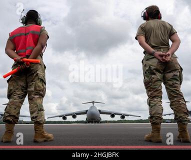 Die Senior Airmen Deondre Douglas und Janelle Ortwein, beide Leiter der 512. Maintenance Squadron Crew, warten auf eine C-5M Super Galaxy zum Taxi, bevor sie vom Dover Air Force Base, Delaware, 16. August 2021 zum Hamid Karzai International Airport, Afghanistan, abheben. Air Mobility Airmen spielen eine Schlüsselrolle bei der Gewährleistung eines sicheren Abflugs von US-amerikanischem und alliiertem Personal aus Afghanistan über zivile und militärische Flüge. Stockfoto