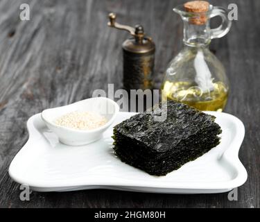 Asiatische Lebensmittel Laver, Gewürzte Laver, Sesamöl, Sesamsamen, Schwarzer Pfeffer. Stockfoto