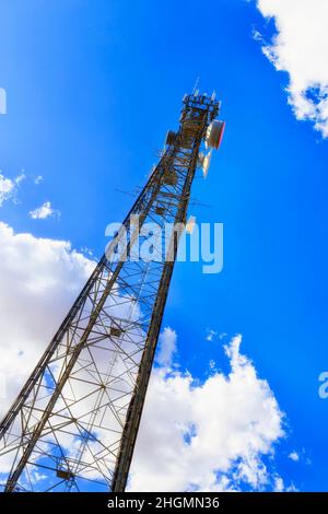 Generic mobile telecommunications transmission tower in remote australian outback against blue sky Stock Photo