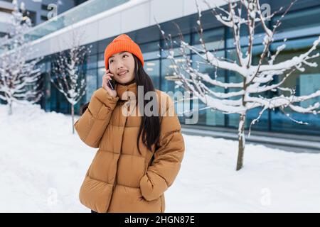 Aufgeregt glücklich koreanische Frau sprach per Handy und lachend, hörte sie gute Nachrichten. Portrait von fröhlichen asiatischen Hipster halten Smartphone Stockfoto
