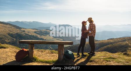 Ein paar Wanderer mit Rucksäcken vor dem Landscape Valley View auf einem Berg