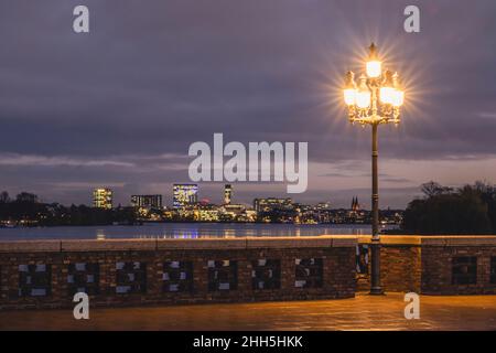 Deutschland, Hamburg, Skyline der Stadt von der Krugkoppelbrücke bei Nacht mit Straßenlicht im Vordergrund Stockfoto