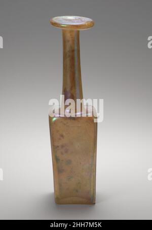 Glasflasche 'Merkur' aus dem 3rd. Jahrhundert n. Chr. römisch farblos mit hellgelbgrüner Färbung. Breiter Rand, ausgeklappt, nach unten, rund und innen und auf der Oberseite abgeflacht; dickwandiger zylindrischer Hals, sich nach unten ausdehnend; eingeschobene horizontale Schulter mit erhöhten abgerundeten Ecken; quadratischer, dickwandiger Körper, mit flachen Seiten; Konkaver Boden.im Relief auf der Unterseite, stehender Pfau, nach rechts zeigend, mit Kamm über Kopf und Schwanzfedern hinter stilisiert mit zwei kreisförmigen Punktreihen.intakt; stumpfen, beißen und brilliantes Schillern, das fast alle Oberflächen bedeckt.Flaschen dieses Typs sind Stockfoto