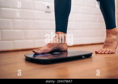 Detail der Frau, die auf eine Badezimmerwaage. Diät Probleme Konzept Stockfoto