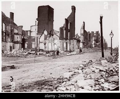 Ruins in Carey Street, Richmond 1865 Thomas C. Roche American von der frühen Karriere von Thomas C. Roche ist nur sehr wenig bekannt. Während des Bürgerkrieges arbeitete er für E. & H. T. Anthony Company, New York, Verleger von Cartes-de-Visite und stereoskopischen Ansichten und Vertreiber von Fotoartikeln. Anfang April 1865, kurz vor Kriegsende, erhielt Roche von Anthony Sonderaufträge für General Montgomery Meigs. Als Quartiermeister der Unionsarmee war Meigs für die Beschaffung und den Transport von allem, von den Panzern bis zur Artillerie, verantwortlich. Er war auch ein Amateurfotograf und Recog Stockfoto