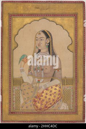 Eine bejeweled Maiden mit einem Sittich ca. 1670–1700 Diese junge Schönheit, die durch einen gekippten Bogen gesehen wird, wurde als Tochter des Mogulherrscher Aurangzeb idealisiert. Die Konvention einer Frau, die einen Sittich hält, wird in der Deccani-Malerei und den Textilien gesehen und ist auch aus einer langjährigen Tradition in der indischen Skulptur bekannt; hier ist die prominente Verwendung von Gold typisch für den Deccani-Geschmack. Der Vogel sitzt auf den Henna-geröteten Fingern des Mädchens, von denen jeder separat von einem Diamantring geschmückt ist. Ein Bejeweled Maiden mit einem Sittich 457771 Stockfoto
