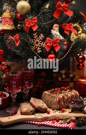 Traditionelle französische Terrine mit Speck und geschmücktem Weihnachtsbaum Stockfoto