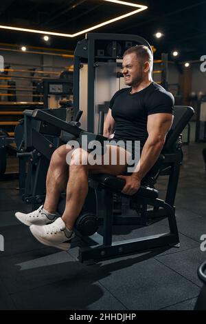 Männliche Bodybuilder trainieren an Fitnessgeräten Stockfoto