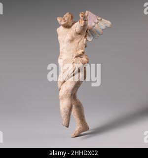 Terracotta-Statuette von Eros 3rd. Jahrhundert v. Chr. Griechisch, Süditalien, Tarentin die überlebenden Spuren von Blau und Purpur auf den Flügeln geben einige Hinweise auf die ursprüngliche Polychromie. Terrakotta-Statue von Eros. Griechisch, Süditalien, Tarentine. 3rd Jahrhundert v. Chr.. Terrakotta. Hellenistisch. Terrakotta Stockfoto