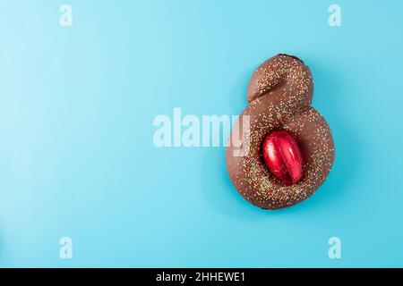Osterkuchen mit Überraschungsei auf blauem Hintergrund Stockfoto